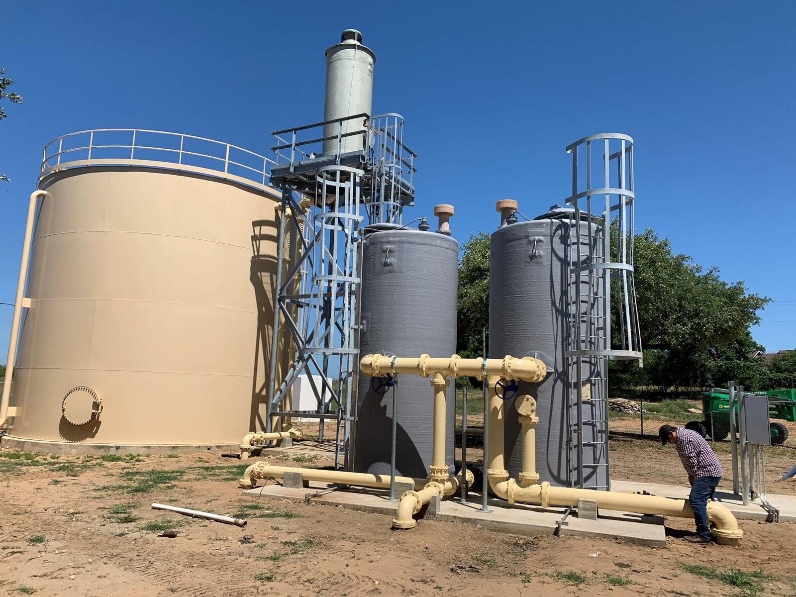 WETS ion exchange vessels beside a ground storage tank
