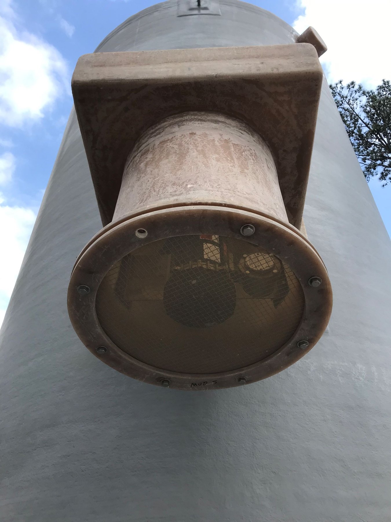 Close-up of a ventilation stack screen on a ground storage tank