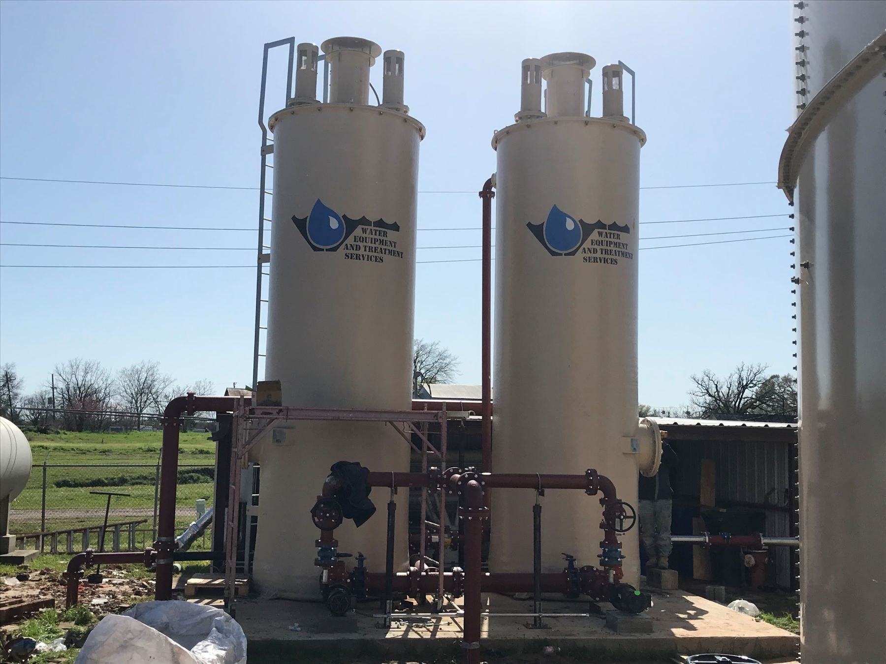 Two WETS-branded WAFU vessels with vent stacks at a treatment site